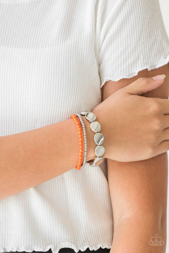 Paparazzi Beyond The Basics - Orange - Bracelet  -  Mismatched silver and orange beads and round silver accents are threaded along stretchy bands, creating colorful layers around the wrist.
