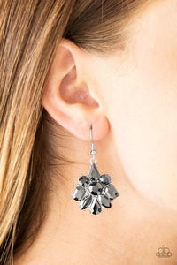 Paparazzi Fiercely Famous - Silver Varying in cut and shimmer, glittery hematite rhinestones coalesce into a blinding lure for a dramatic look. Earring attaches to a standard fishhook fitting.


