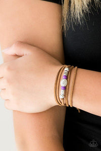Paparazzi Clear A Path - Purple An array of purple and silver beads are knotted in place along elongated suede cording for a wanderlust fashion. To secure bracelet, tie ends in place around the wrist at desired length.

