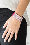 Paparazzi Rebel Radiance - Pink  -  Featuring classic round and edgy emerald style cuts, glittery white rhinestones and glistening silver chains are encrusted along bands of pink suede for a sassy look. Features an adjustable snap closure.
