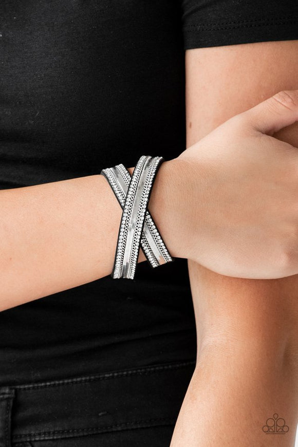 Paparazzi Rocker Rivalry - Black - Bracelet  -  Rows of classic silver chain, flat silver chain, and dainty white rhinestones are encrusted along a black suede band for a sassy look. The elongated band allows for a trendy double wrap design. Features an adjustable snap closure.

