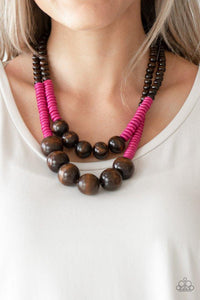 Paparazzi Cancun Cast Away - Pink  -  Earthy brown and vivacious pink wooden beads and discs are threaded along shiny strands of brown cording, creating colorful layers. Features a button loop closure.
