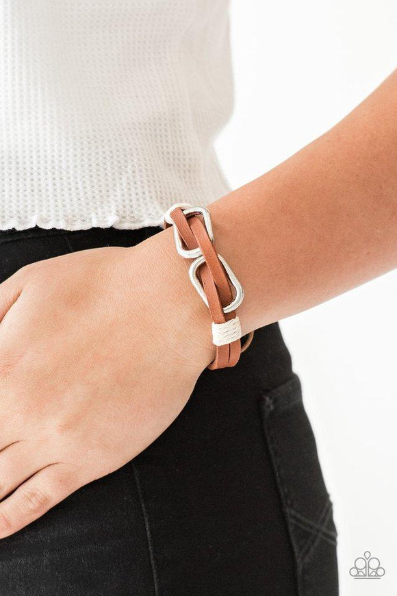 Paparazzi MOUNTAINEER Time Zone - White Infused with white cording, strips of brown leather lace through silver links for an adventurous look. Features an adjustable sliding knot closure.

