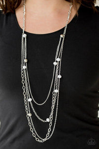 Paparazzi Glamour Grotto- White Opaque white crystal-like beads and shimmery silver beads trickle along mismatched silver chains, creating refined layers down the chest. Features an adjustable clasp closure.

