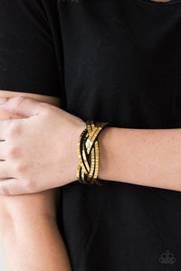 Paparazzi Looking For Trouble - Gold - Bracelet  -  Flat gold cubes are encrusted along rows of braided black suede for an edgy look. Features an adjustable snap closure.
