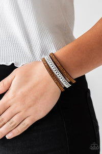 Paparazzi Rollin In Rhinestones - Brown - Bracelet  -  Rows of glassy topaz and white rhinestones and a shimmery silver chain are encrusted along brown suede bands for a sassy look. Features an adjustable snap closure.
