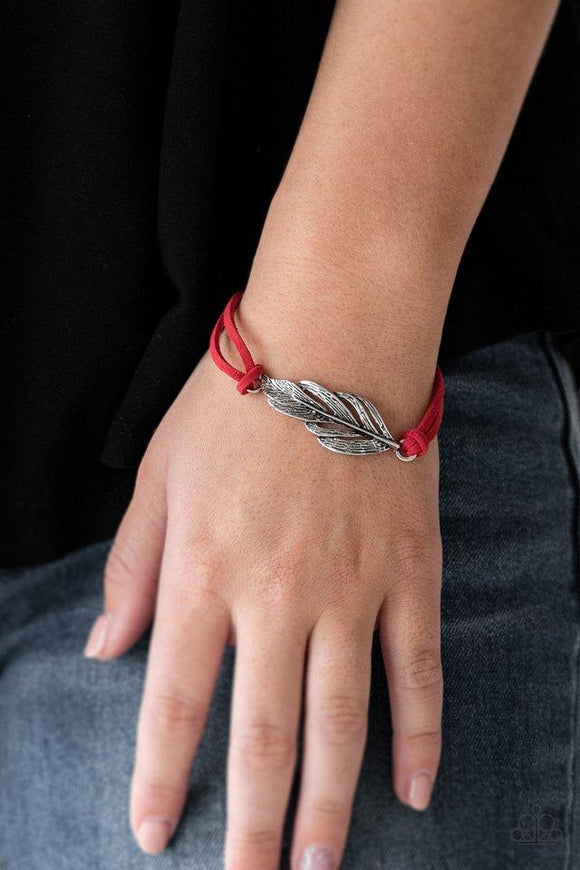 Paparazzi Faster Than FLIGHT - Red Strands of fiery red suede knot around a shimmery silver feather charm, creating a seasonal pendant atop the wrist. Features an adjustable clasp closure.

