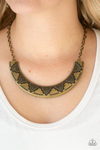 Paparazzi Persian Pharaoh - Brass Stamped in decorative geometric patterns, an antiqued brass crescent plate swings below the collar for a tribal inspired look. Features an adjustable clasp closure.

