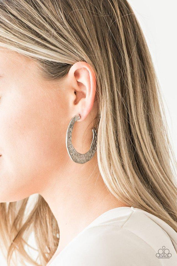 Paparazzi The HOOP Up - Silver  -  Radiating with hammered detail, an asymmetrical silver hoop curls around the ear for a casual look. Earring attaches to a standard post fitting. Hoop measures 2