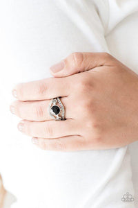 Paparazzi Rich With Richness - Black A hematite rhinestone encrusted band and glistening silver band wave around a radiating black and hematite rhinestone center for a refined look. Features a dainty stretchy band for a flexible fit.

