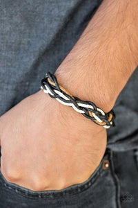 Paparazzi Mountain Quest - Black  -  Black, brown, and white twine weave across the wrist, creating an urban braid across the wrist. Features an adjustable sliding knot closure.
