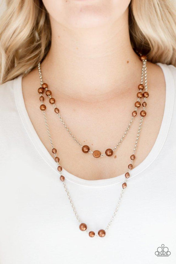 Paparazzi Pearl Promenade - Brown Varying in size and shape, pearly brown beads trickle along two silver chains, creating refined layers across the chest. Features an adjustable clasp closure.

