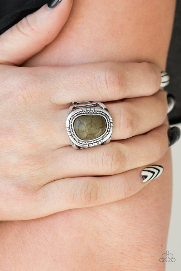 Paparazzi Out On The Range - Green - Ring  -  An earthy Military Olive stone is pressed into an asymmetrical silver frame radiating with tactile textures for a seasonal look. Features a stretchy band for a flexible fit.
