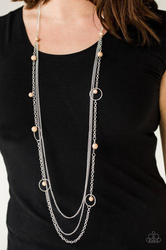 Paparazzi Collectively Carefree- Brown Infused with two plain strands of shimmery silver chains, polished brown beads and shimmery silver hoops trickle along a bold silver chain for a whimsically layered look. Features an adjustable clasp closure.

