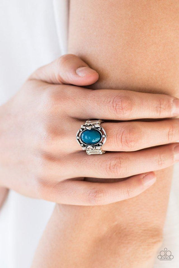 Paparazzi Color Me Confident - Blue A polished blue bead is pressed into the center of a silver frame blooming with floral details for a whimsical finish. Features a stretchy band for a flexible fit.
