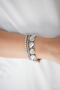 Paparazzi Beyond The Basics - Silver Mismatched silver and gray beads and round silver accents are threaded along stretchy bands, creating colorful layers around the wrist.
