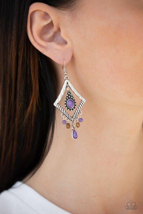 Paparazzi Southern Sunsets - Purple Featuring a vivacious purple bead, a studded silver teardrop swings from the top of a kite-shaped silver frame. Dainty purple and wooden accents swing from the bottom of a hammered frame, creating a seasonal fringe. Earring attaches to a standard fishhook fitting.
