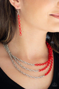 Paparazzi Turn Up The Volume - Red  -  Rows of shimmery silver chain merge with shiny red chains, creating colorful layers below the collar. Features an adjustable clasp closure.
