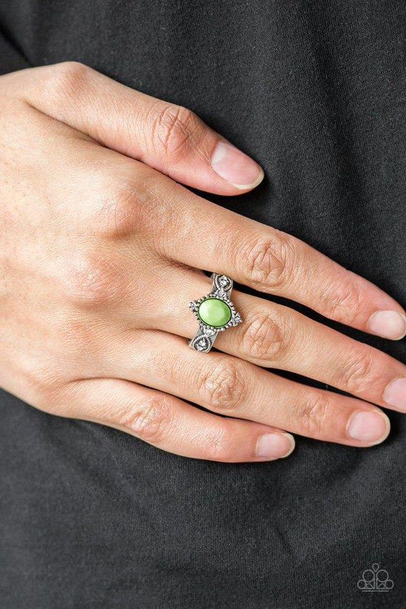 Paparazzi Pricelessly Princess - Green A faceted green bead is pressed into an ornate silver band radiating with silver studs and dainty white rhinestones for a refined look. Features a dainty stretchy band for a flexible fit.

