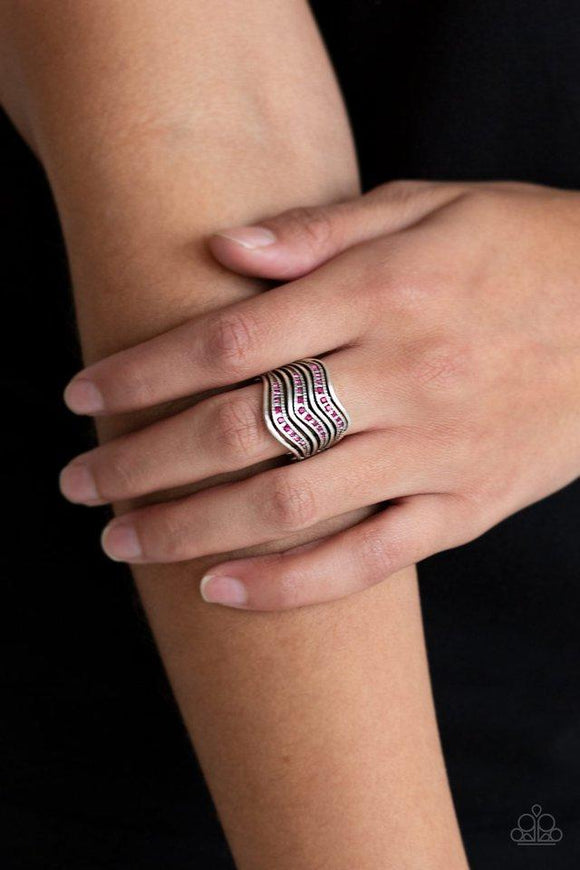 Paparazzi Fashion Finance - Pink  -  Dotted in glittery pink rhinestones, studded silver bars and smooth silver bars wave across the finger into edgy stacks. Features a stretchy band for a flexible fit.
