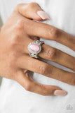 Paparazzi Laguna Luxury - Pink  -  A glowing pink moonstone is pressed into the center of a silver frame radiating with glassy white rhinestones for a refined flair. Features a stretchy band for a flexible fit.
