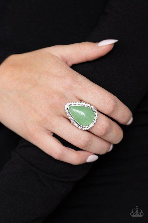 Paparazzi Mojave Mist - Green  -  Chiseled into a tranquil teardrop, a misty green stone is pressed into a textured silver teardrop frame for a seasonal look. As the stone elements in this piece are natural, some color variation is normal. Features a stretchy band for a flexible fit.
