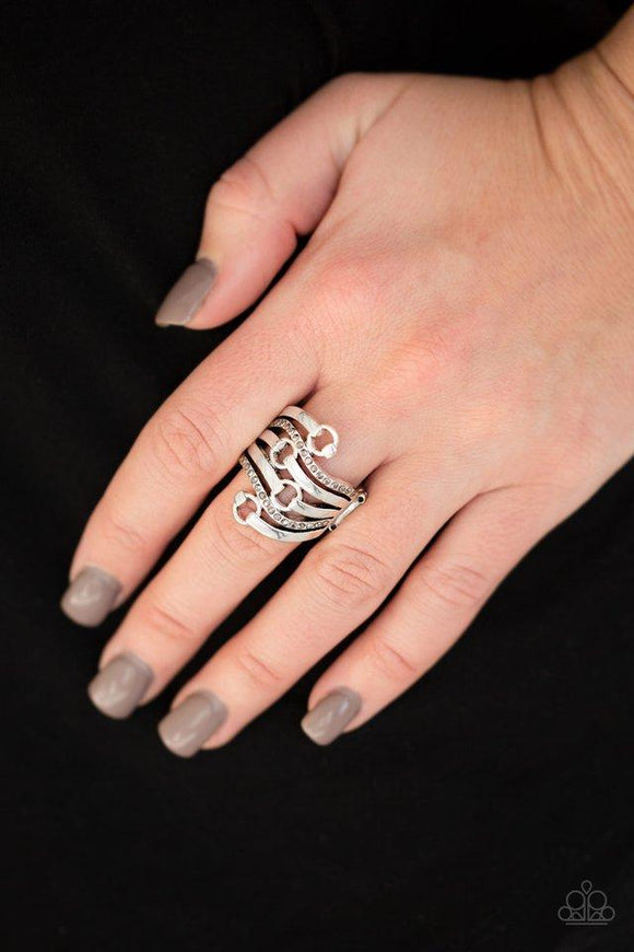 Paparazzi Buckle Up - Silver Plain silver and hematite encrusted silver bands wave across the finger, linking with dainty silver hoops for a buckled look. Features a stretchy band for a flexible fit.

