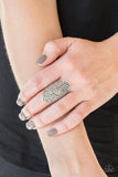 Paparazzi Shazam - Silver Encrusted in row after row of glittery hematite rhinestones, a dramatic silver frame folds around the finger for a statement-making finish. Features a stretchy band for a flexible fit.

