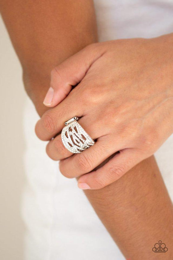 Paparazzi The Money Maker - White Radiating with dainty white rhinestones, glittery silver bands crisscross across the finger for a refined look. Features a stretchy band for a flexible fit.

