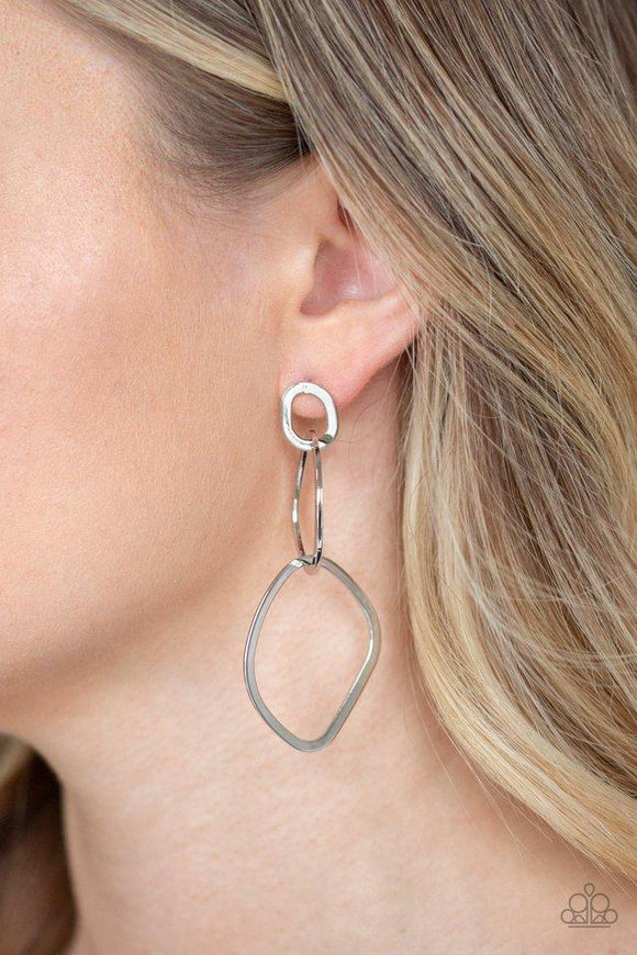 Paparazzi Twisted Trio - Silver A trio of asymmetrical silver hoops link as they tumble from the ear, coalescing into an abstract lure. Earring attaches to a standard post fitting.

