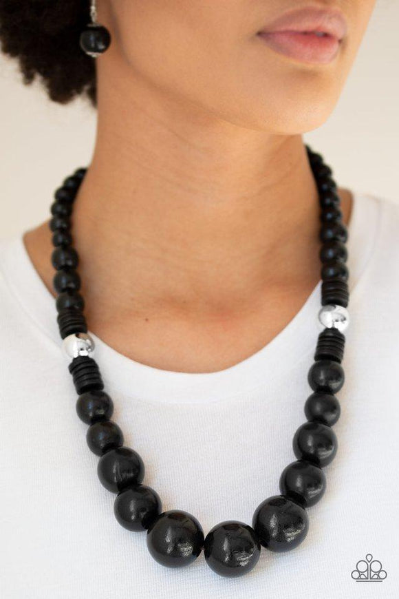 Paparazzi Panama Panorama - Black Infused with dramatic silver beads, an array of shiny black wooden beads drape across the chest for a summery look. Features a button-loop closure.

