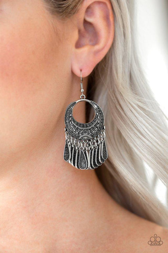 Paparazzi Mesa Majesty - Silver  -  Studded silver teardrops swing from the bottom of an ornate silver hoop radiating with tribal inspired patterns for an indigenous flair. Earring attaches to a standard fishhook fitting.
