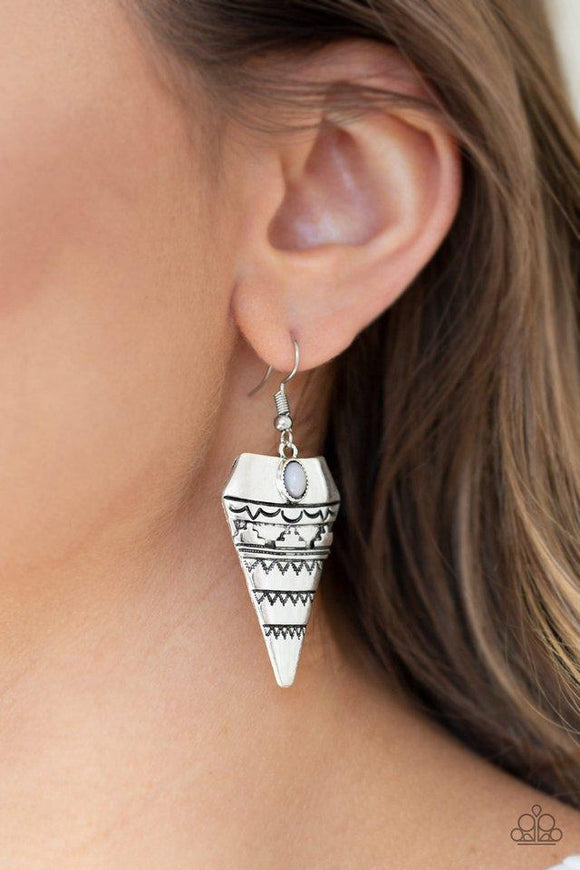 Paparazzi Jurassic Journey - Silver Stamped and embossed in tribal inspired patterns, an antiqued triangular frame swings from the ear. A dainty gray bead is pressed into the top of the frame for a refreshing splash of color. Earring attaches to a standard fishhook fitting.
