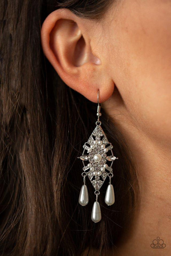 Paparazzi Majestic Mood - White Dotted with dainty white pearls, a silver kite-shaped frame is encrusted in glassy white rhinestones. Teardrop pearls swing from the bottom of the sparkling frame for a refined flair. Earring attaches to a standard fishhook fitting.


