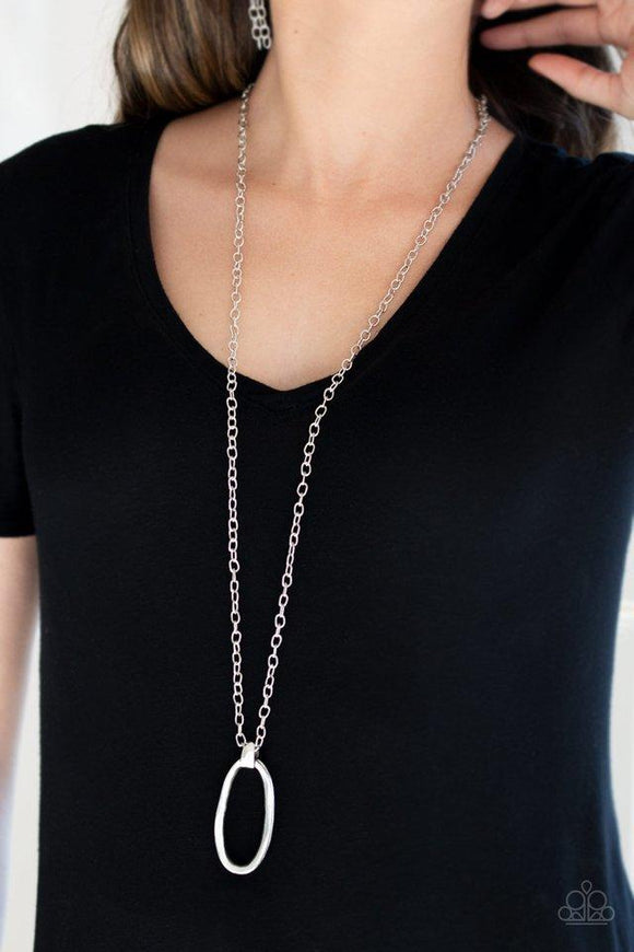 Paparazzi Grit Girl - Silver Delicately hammered in a gritty antiqued finish, a bold asymmetrical silver ring swings from the bottom of a lengthened silver chain for an industrial look. Features an adjustable clasp closure.

