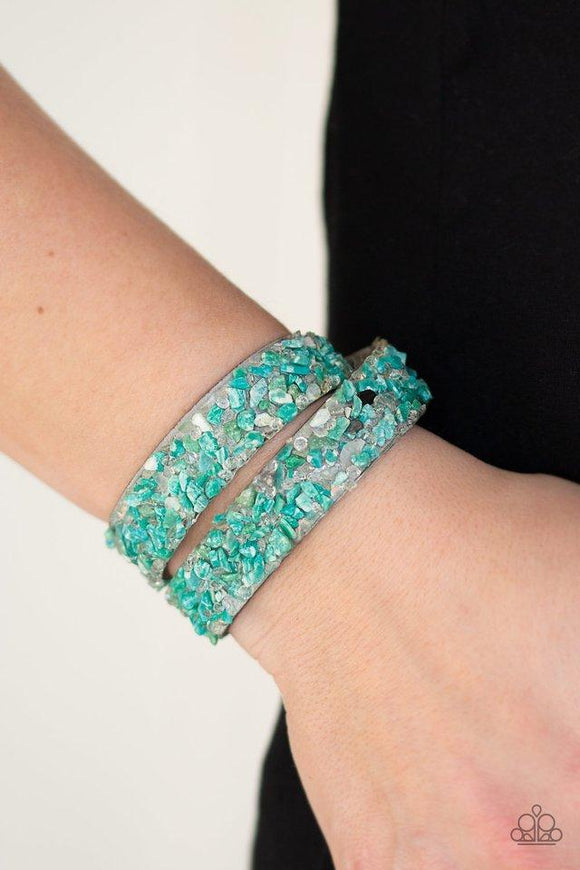 Paparazzi CRUSH To Conclusions - Green  -  A collection of crushed green rocks and glassy white rhinestone prisms are sprinkled across a gray suede band for a seasonal look. The elongated band allows for a trendy double wrap design. Features an adjustable snap closure.
