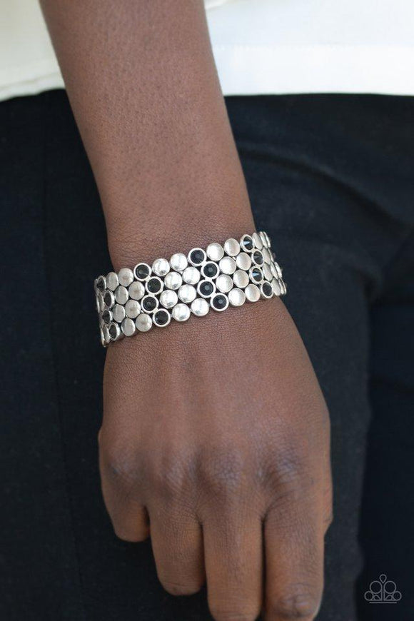Paparazzi Scattered Starlight - Black  -  A collection of frames featuring flat silver studs and glittery black rhinestones are threaded along a stretchy band, scattering sparkle across the wrist.
