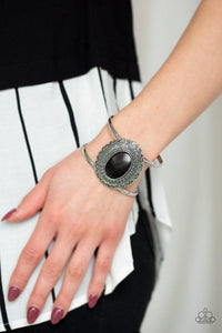 Paparazzi Extra EMPRESSive - Black An earthy black stone is pressed into the center of a scalloped silver frame radiating with swirly filigree detail. The colorful stone frame sits atop an airy silver cuff for a simply seasonal look.

