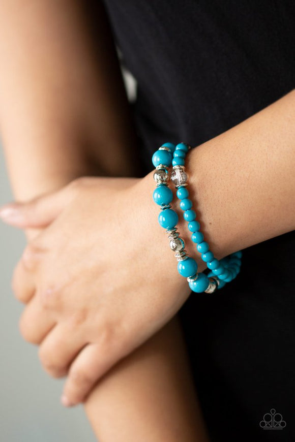Paparazzi Colorful Collisions - Blue - Bracelet  -  A collection of polished blue, shiny silver, and faceted crystal-like beads are threaded along stretchy bands around the wrist for a colorfully layered look.
