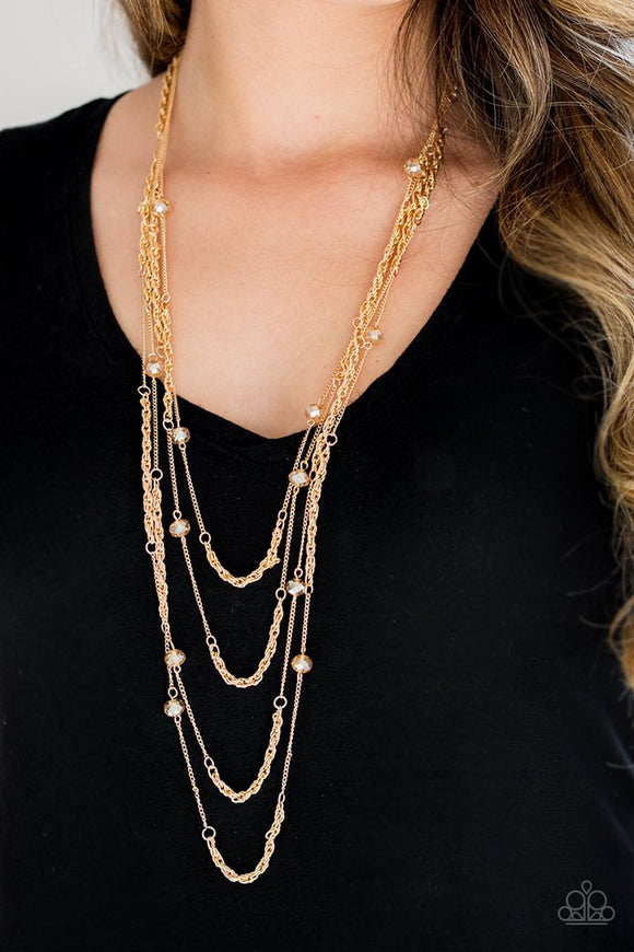 Paparazzi Open For Opulence - Gold - Necklace  -  Golden crystal-like beads trickle along three mismatched gold chains, creating shimmery layers across the chest. Features an adjustable clasp closure.
