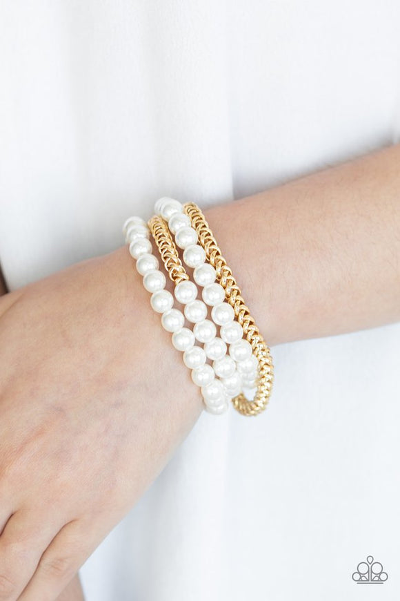 Paparazzi Industrial Incognito - Gold - Bracelet  -  A collection of pearly white beads and glistening gold chains are threaded along stretchy bands, creating a bold collision of industrial glamour.
