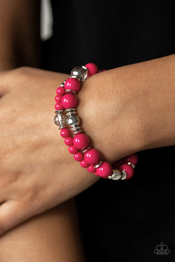 Paparazzi Colorful Collisions - Pink A collection of polished pink, shiny silver, and faceted crystal-like beads are threaded along stretchy bands around the wrist for a colorfully layered look.
