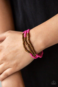 Paparazzi Woodland Wanderer - Pink A collection of vivacious pink stones and dainty wooden beads are threaded along stretchy bands around the wrist for an earthy, layered look.

