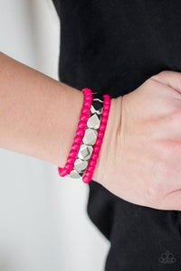 Paparazzi Fiesta Flavor- Pink A collection of polished pink and faceted silver beads are threaded along stretchy bands, creating colorful layers around the wrist.

