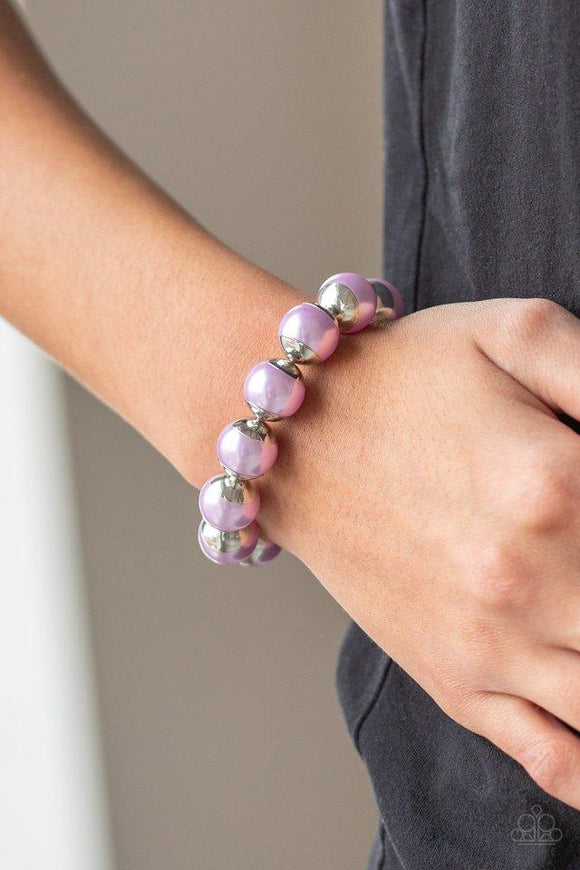 Paparazzi One Woman Show-STOPPER - Purple  -  Capped in silver fittings, oversized purple pearls are threaded along a stretchy band around the wrist for a refined look.
