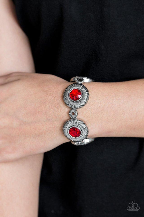 Paparazzi Original Opulence - Red  -  Radiating with fiery red rhinestone centers, dramatic silver frames and dainty silver beads are threaded along a stretchy band for an edgy style.
