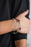 Paparazzi City Slicker Sleek - Red Brushed in an antiqued shimmer, a collection of smooth and textured silver bangles stack across the wrist. Varying in shape and size, glittery red and white rhinestones are encrusted along one bangle for a glamorous glow.
