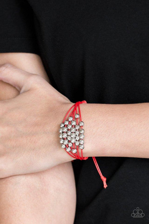 Paparazzi Without Skipping A BEAD - Red Shiny silver beads are threaded along row after row of shiny red cording around the wrist for a colorful look. Features an adjustable sliding knot closure.

