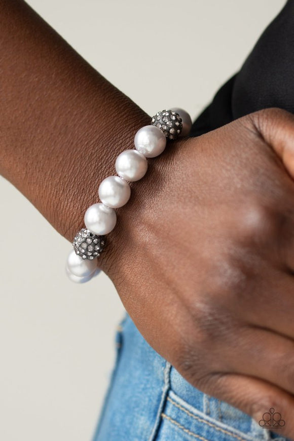 Paparazzi Cake Walk - Silver - Bracelet  -  A collection of silver pearls and smoky rhinestone encrusted beads are threaded along a stretchy band around the wrist for a refined flair.
