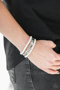 Paparazzi Fiesta Flavor- White A collection of polished white and faceted silver beads are threaded along stretchy bands, creating colorful layers around the wrist.

